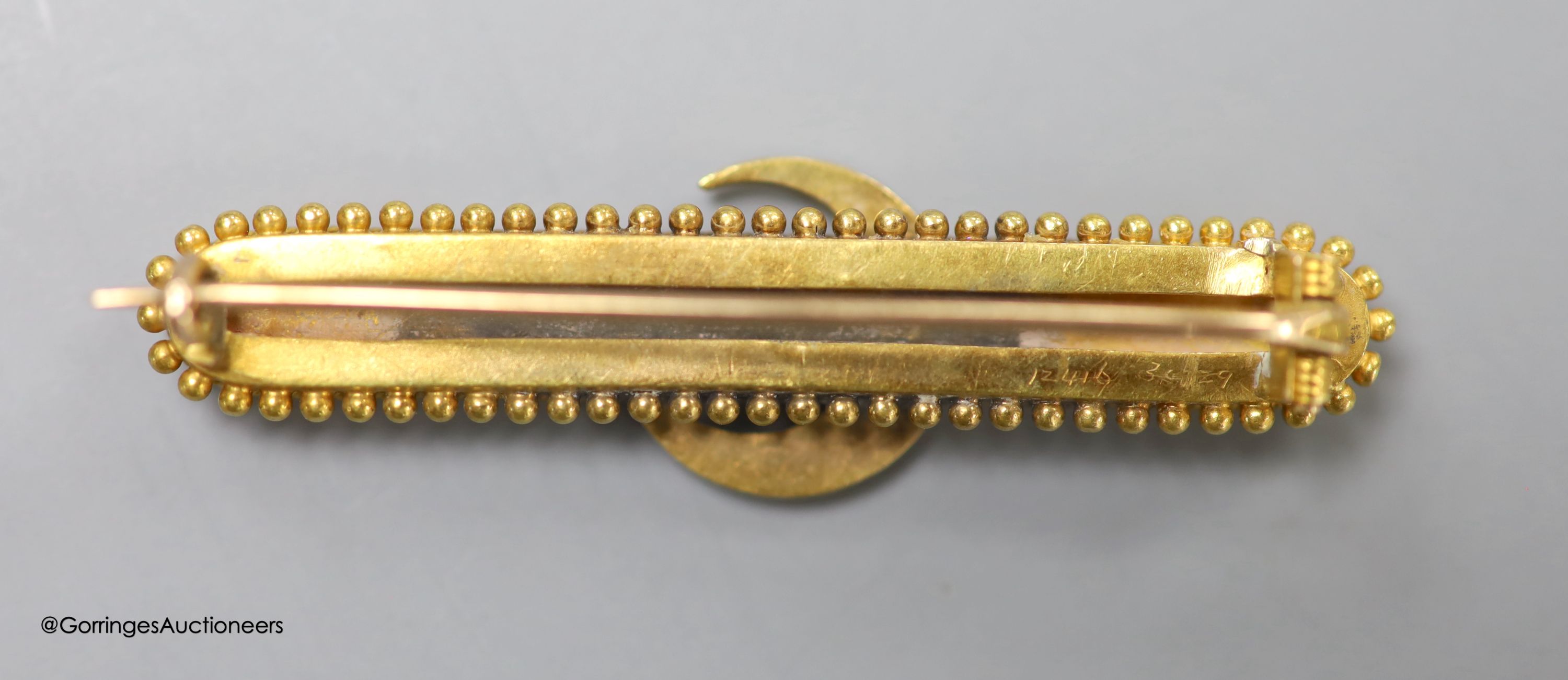 A late Victorian yellow metal and seed pearl set bar brooch, with crescent motif, 46mm, gross weight 5.2 grams.